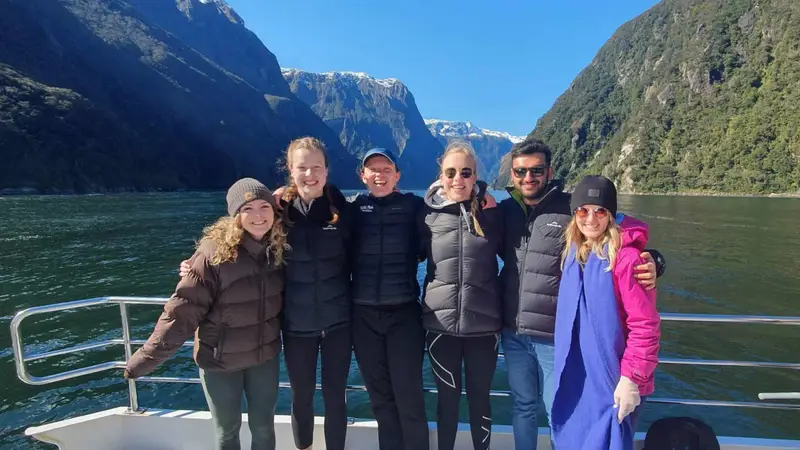 Group of friends on a boat cruise in Milford Sound in New Zealand