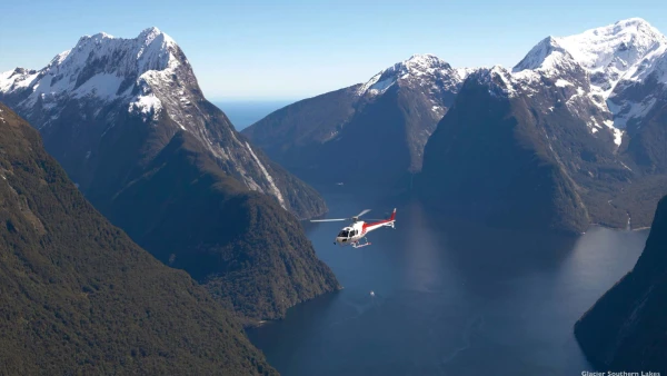 Helicopter flying through Milford Sound