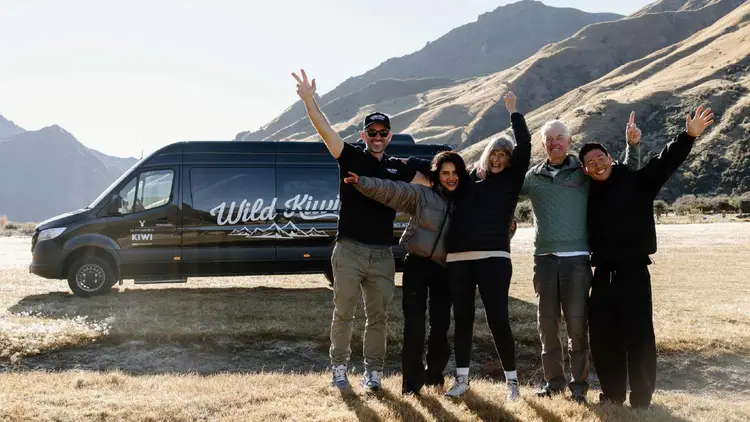 Wild Kiwi group with their guide in front of vehicle