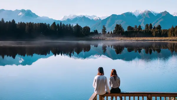 Couple look out at Mirror Lakes in New Zealand