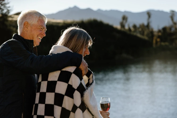 A couple enjoying their time and relaxing over the lake