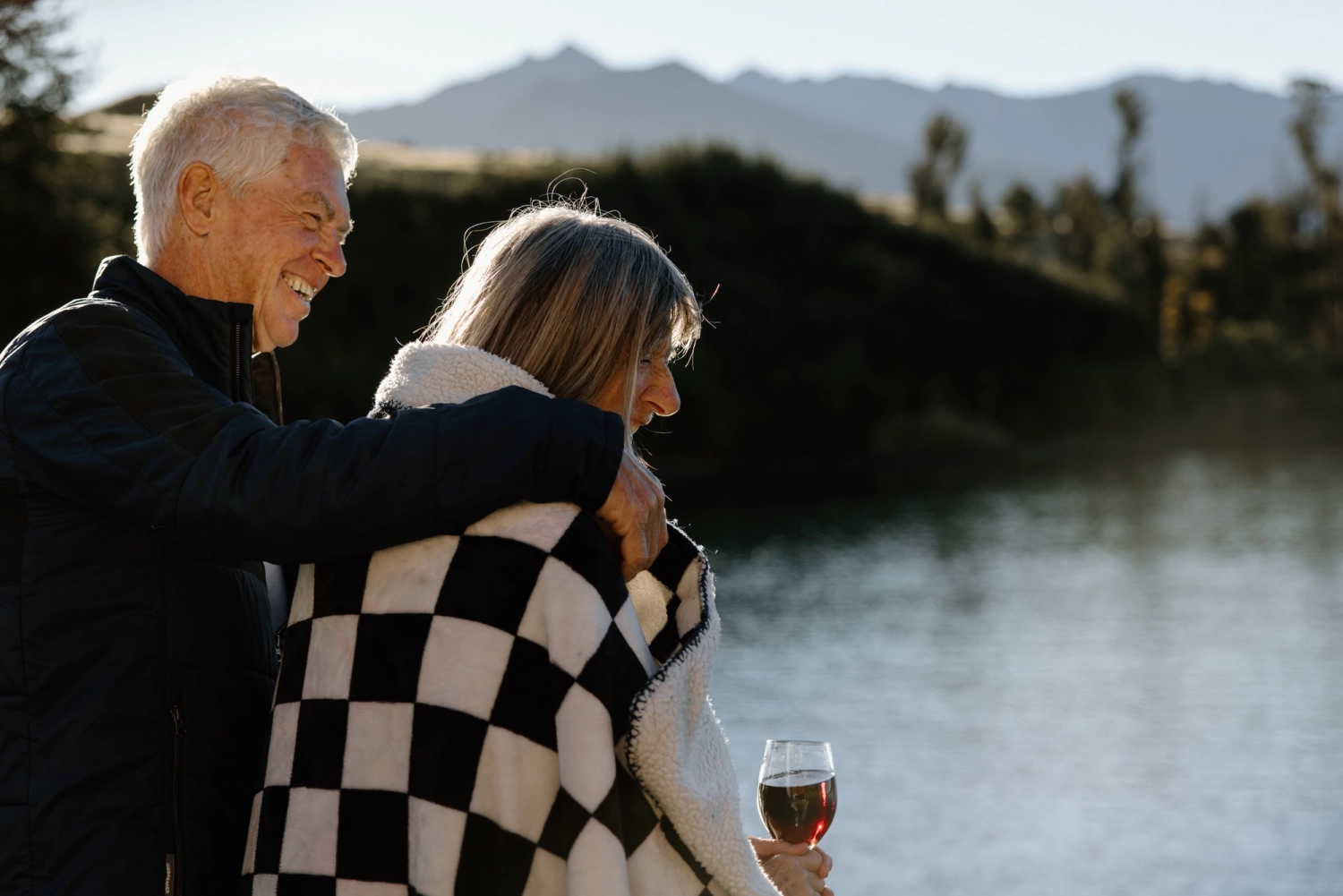 A couple enjoying their time and relaxing over the lake