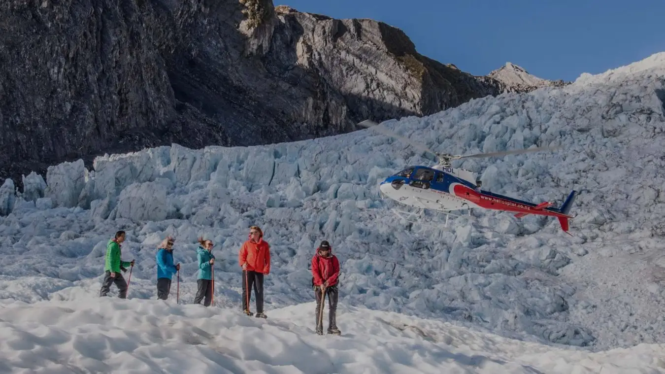 Group of people waiting for a helicopter on Franz Josef Glacier