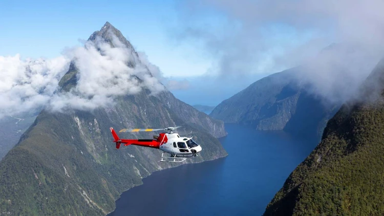 Helicopter flying over Milford Sound