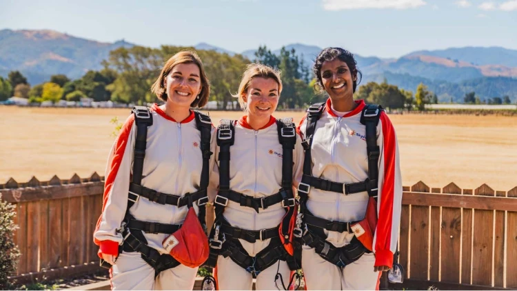 Three women in sky diving suits