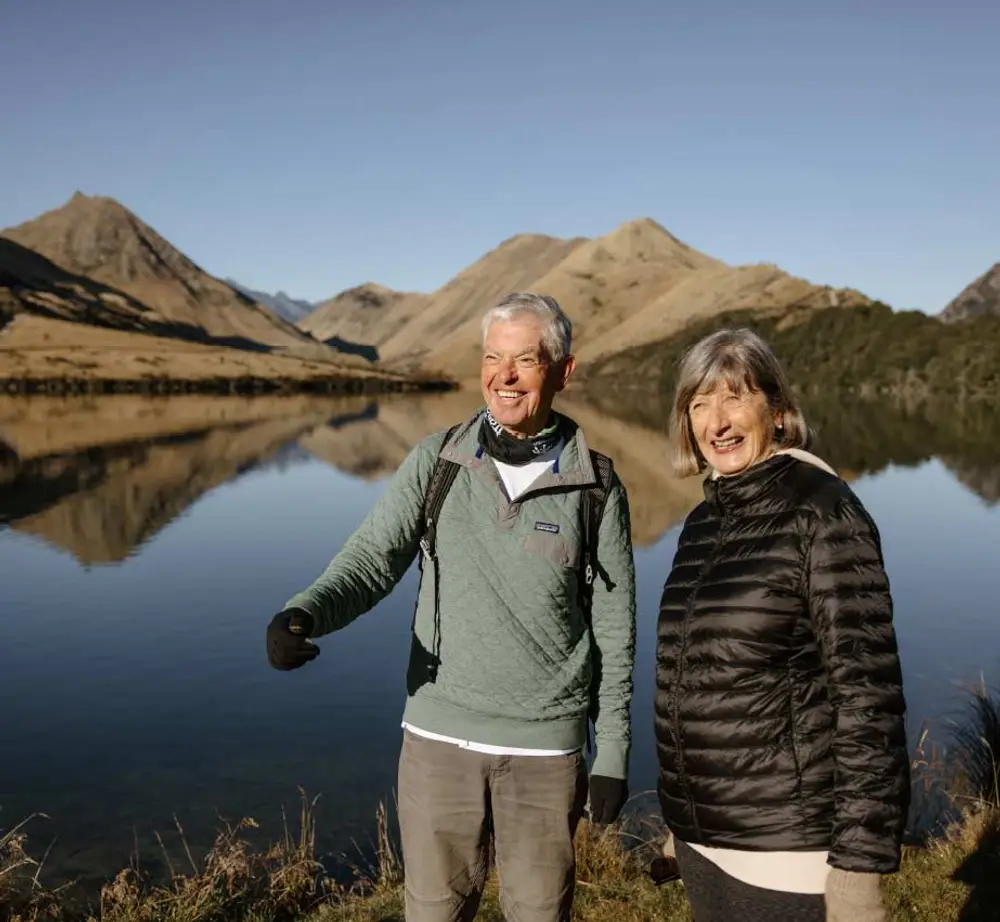 Couple walking next to Moke Lake in New Zealand