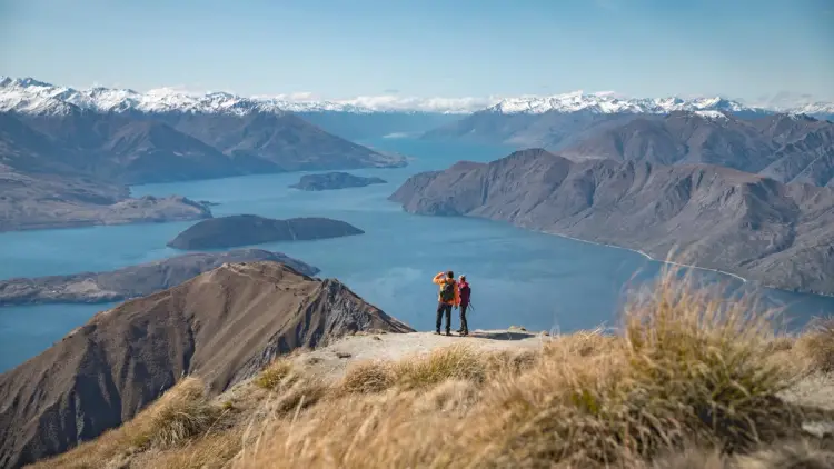 Two people look at the view at Roys Peak