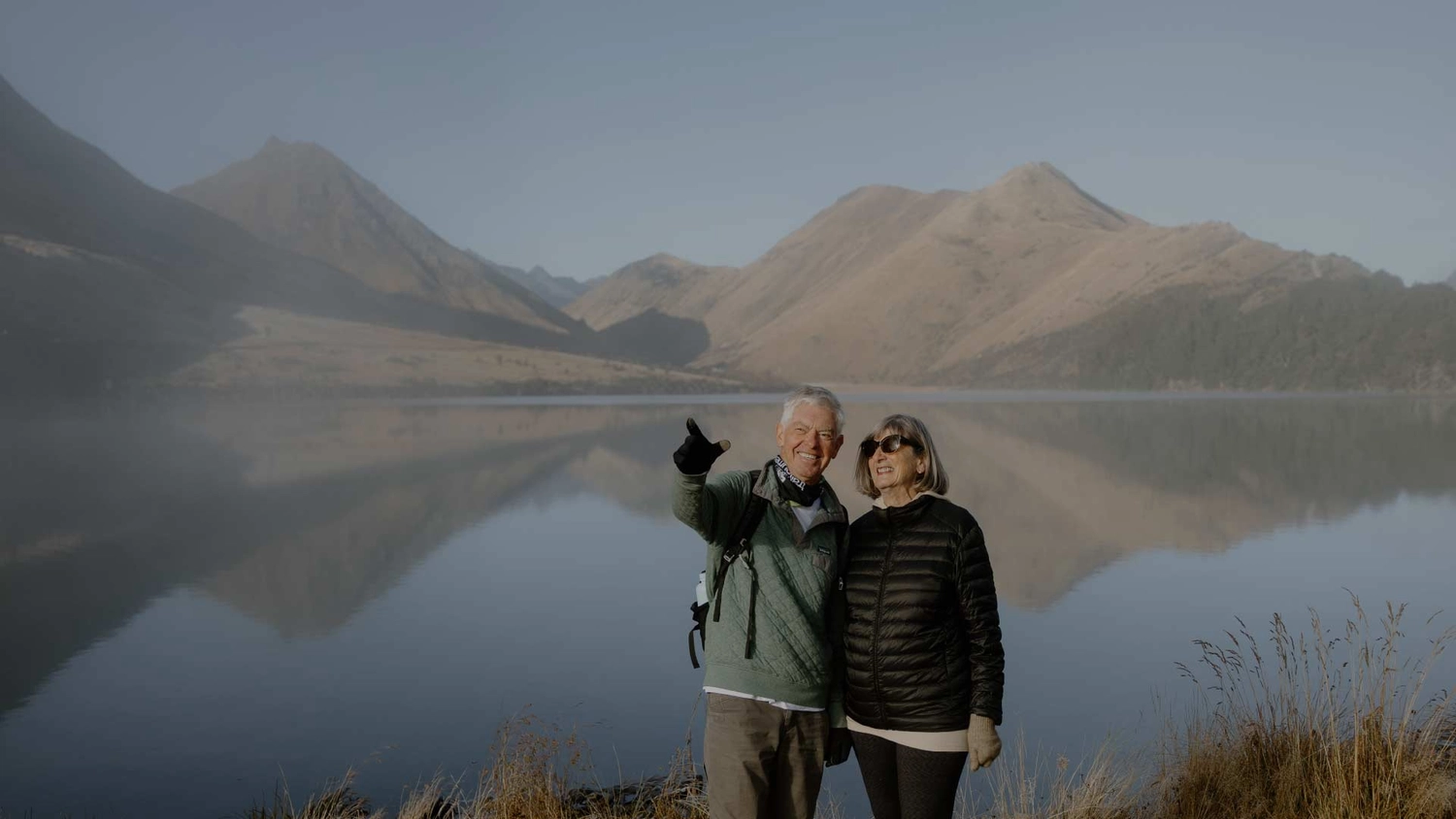 Couple walking along the lakefront at Moke Lake in New Zealand