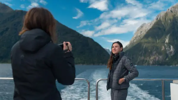 Woman getting photo taken on a Milford Sound Cruise