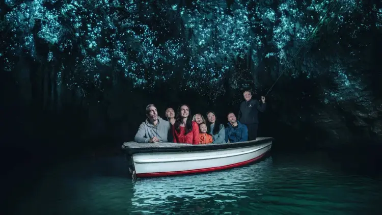 Group on a boat in the Waitomo glowworm caves