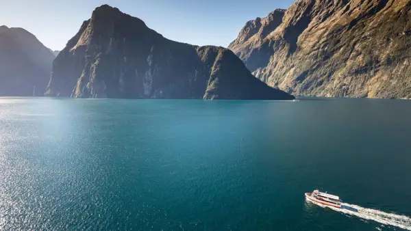 Boat cruising through Milford Sound
