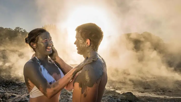Two people taking a mud bath at the Polynesian Spas in Rotorua