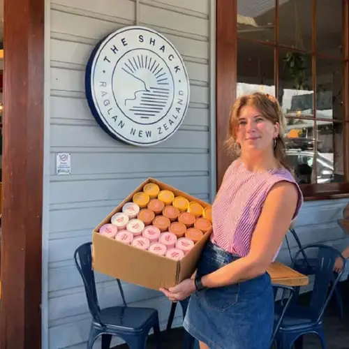 Woman holding a tray of donuts