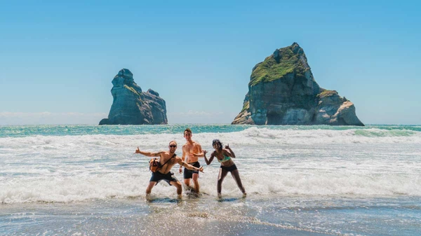 People in the surf at Golden Bay
