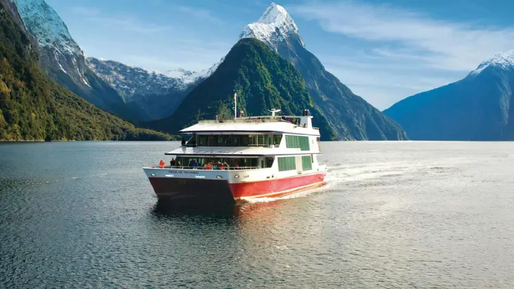 Boat cruising Milford Sound