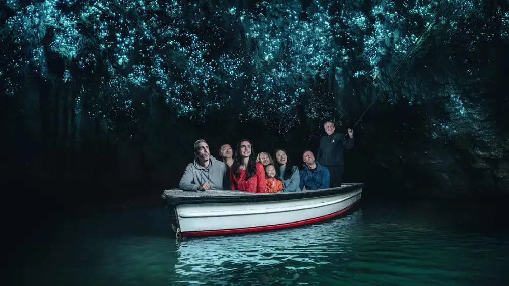 Group on a boat in the Waitomo glowworm caves