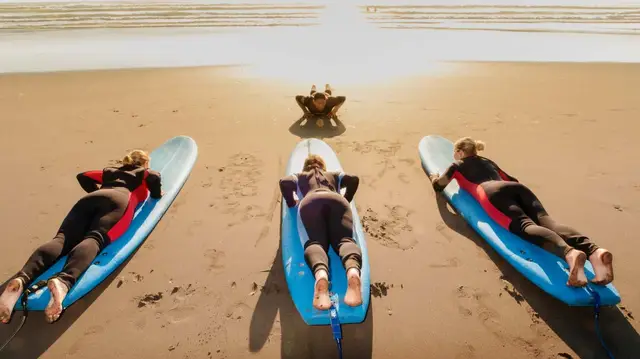 People learning to surf at Raglan