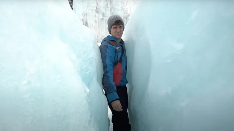 Man squeezing between the ice on Franz Josef Glacier