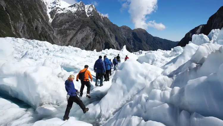 Group of people walking up Franz Josef Glacier