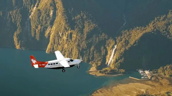 Plane flying through Milford Sound