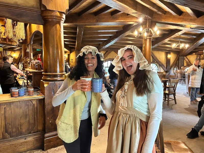 Two new travel friends stand in the Green Dragon Inn in Hobbiton New Zealand