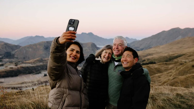 Group of people pose for a photo at Coronet Peak in New Zealand
