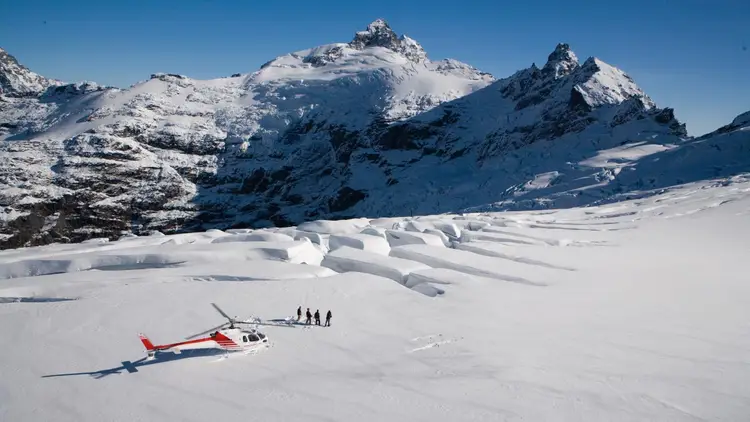 Group of people heli-hiking on Clarke Glacier in New Zealand