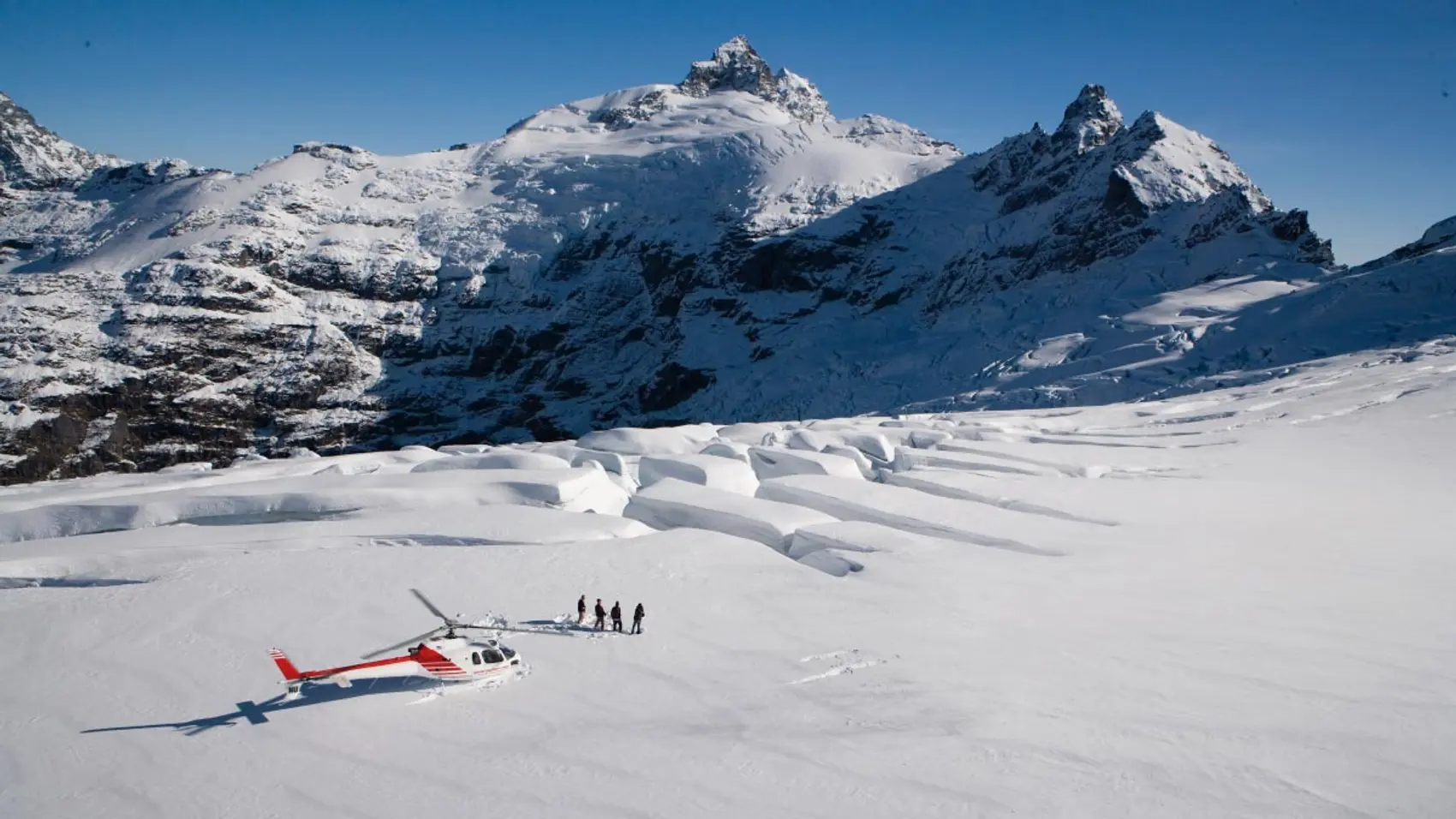 Group of people heli-hiking on Clarke Glacier in New Zealand