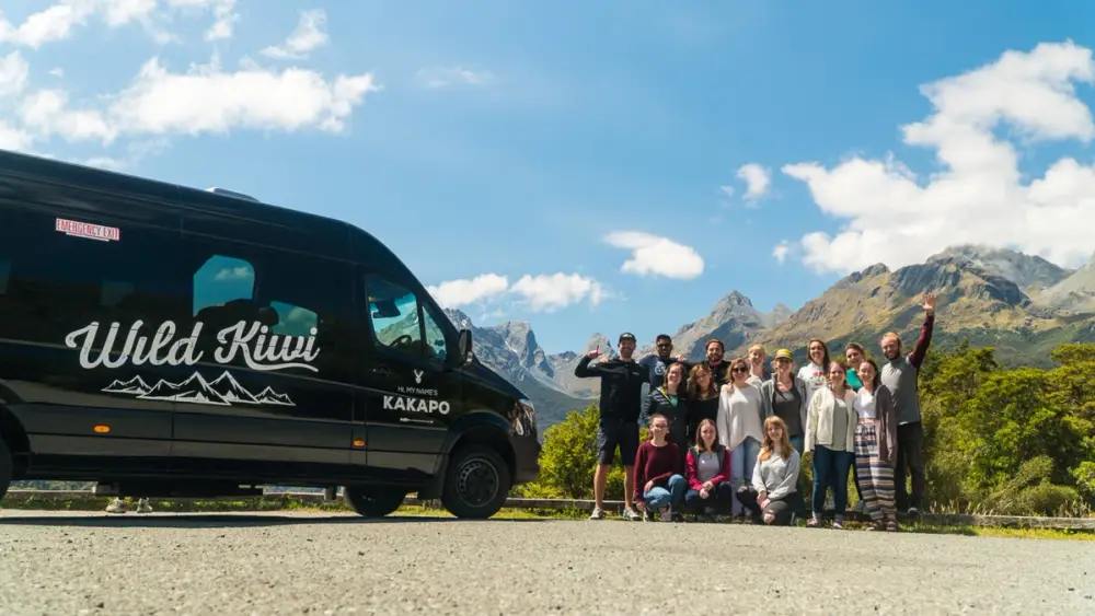 Group of people next to a Wild Kiwi vehicle