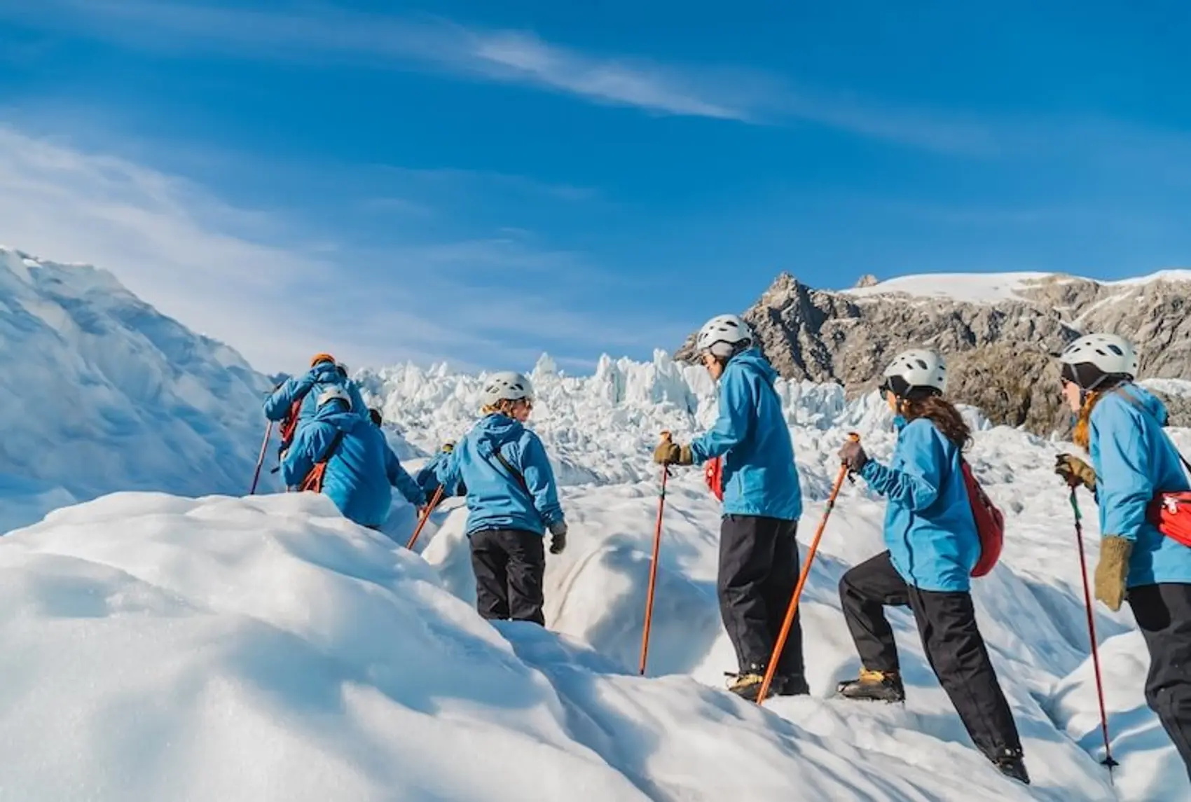 A group of people hiking on ice atop Franz Josef Glacier in New Zealand.