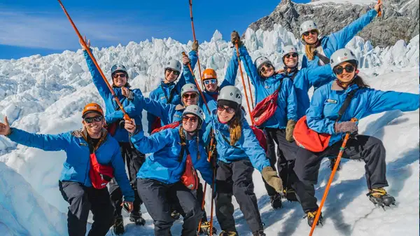 Group of people pose for a photo on Franz Josef glacier