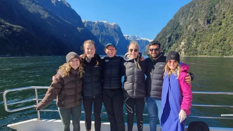 Group of friends on a boat cruise in Milford Sound in New Zealand