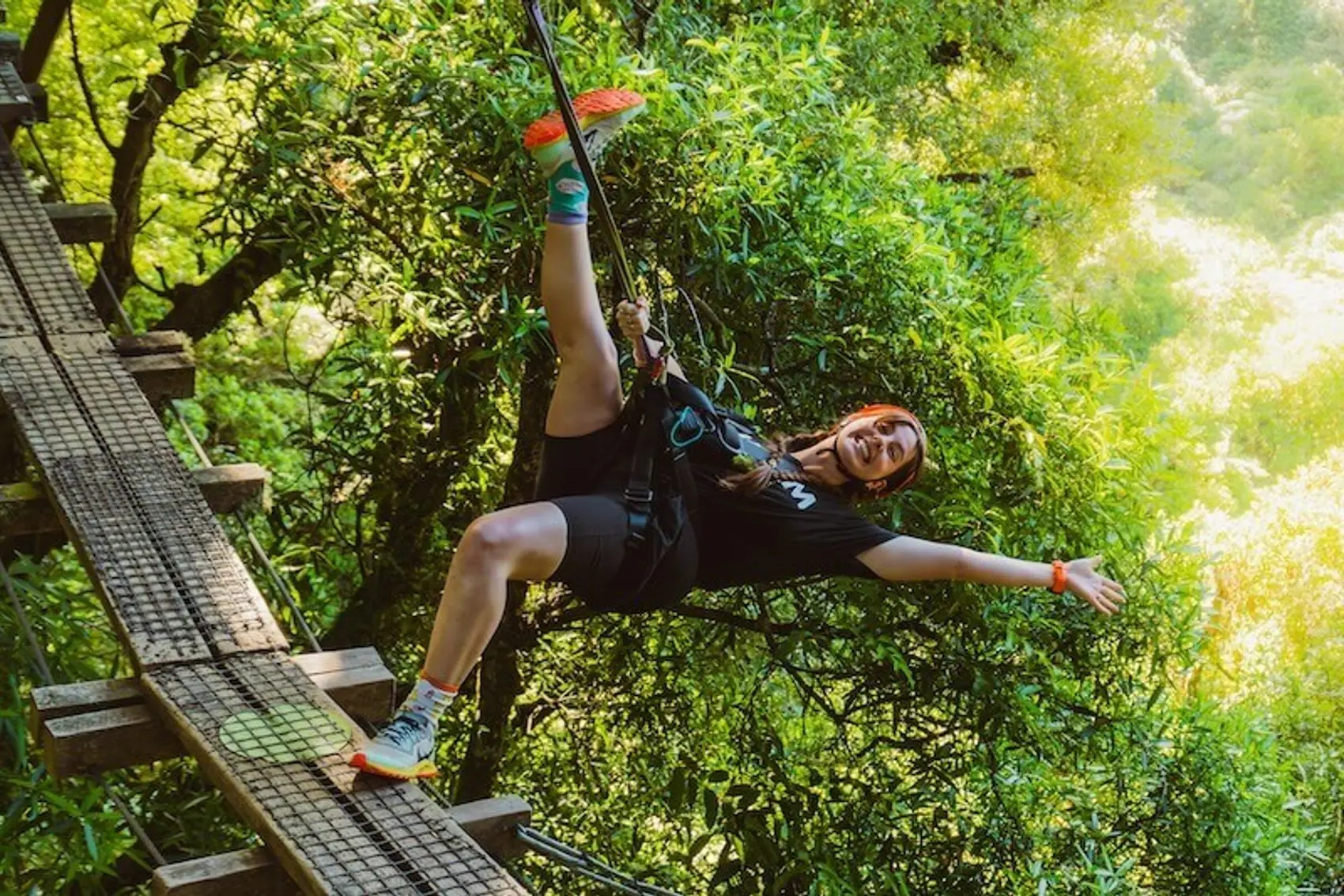 Photo of a female on a canopy zipline tour in Rotorua while on a small group tour around New Zealand. Canopy tour is one of the best summer activities in New Zealand's North Island.