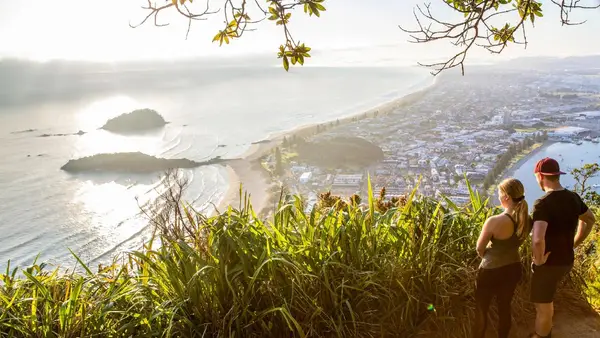 Couple look at the view on top of Mount Maunganui