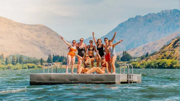 Group of women pose for a photo on a pontoon on Lake Wakatipu