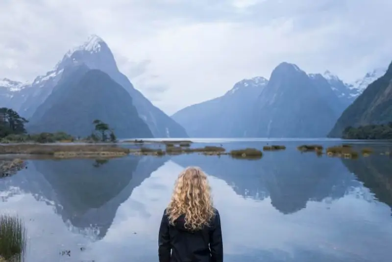 Woman looking out at Milford Sound