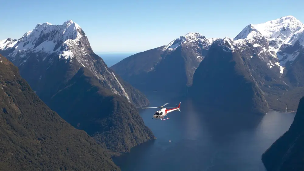 Helicopter flying over Milford Sound
