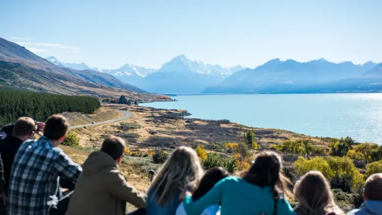 Group of people look at the view over Lake Pukaki