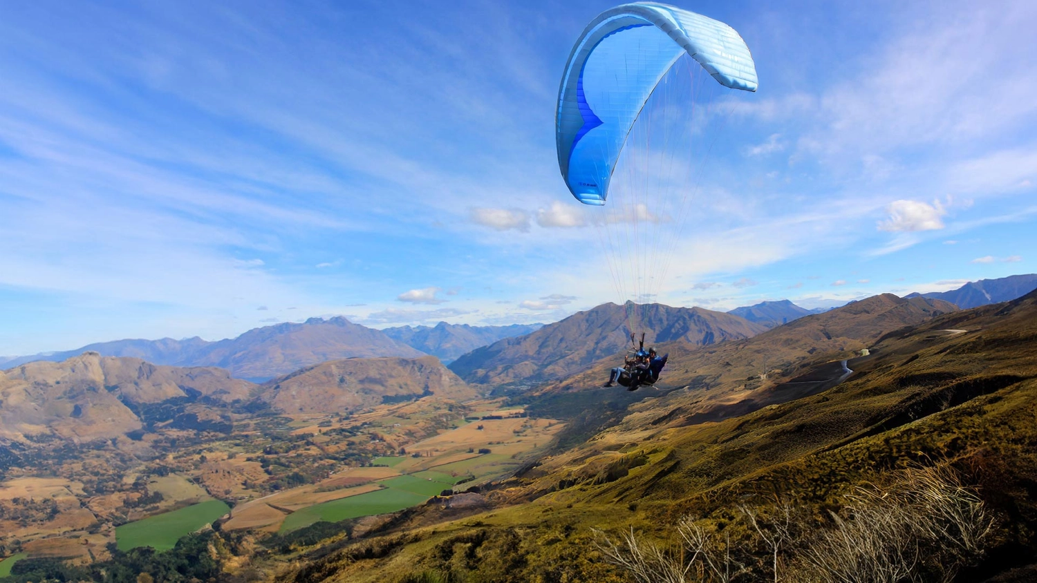 Two people tandem skydiving over Queenstown