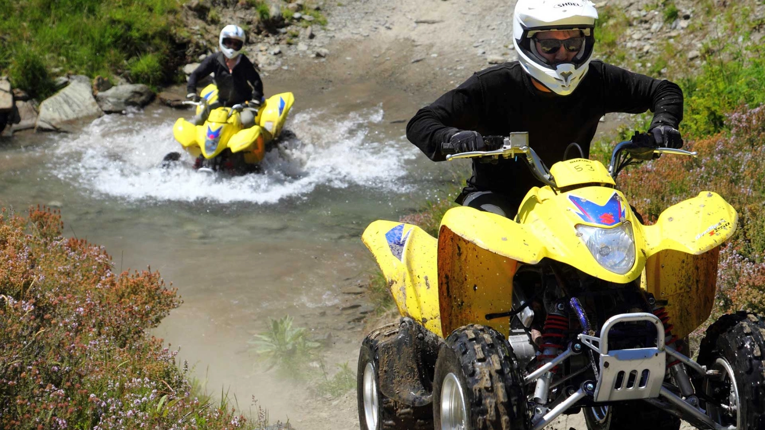 Two people on quad bikes