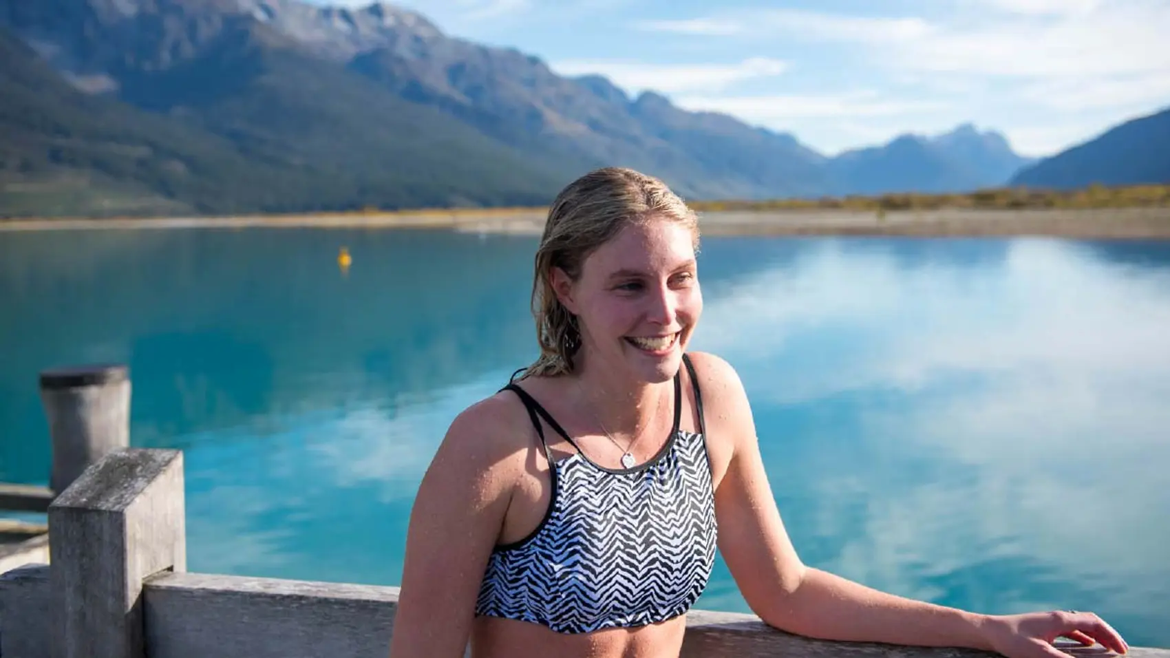 Woman standing in front of Lake Wakatipu in New Zealand