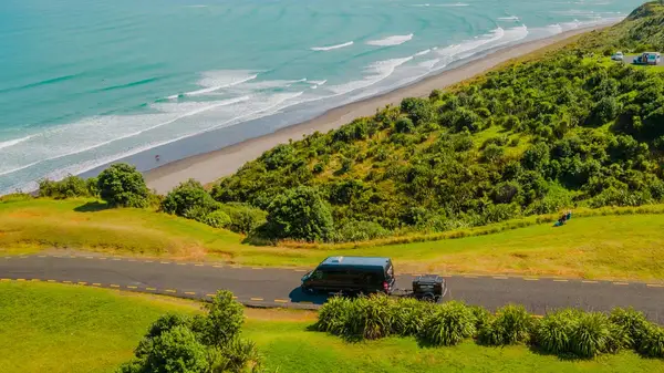 Wild Kiwi bus on the coastal road at Raglan