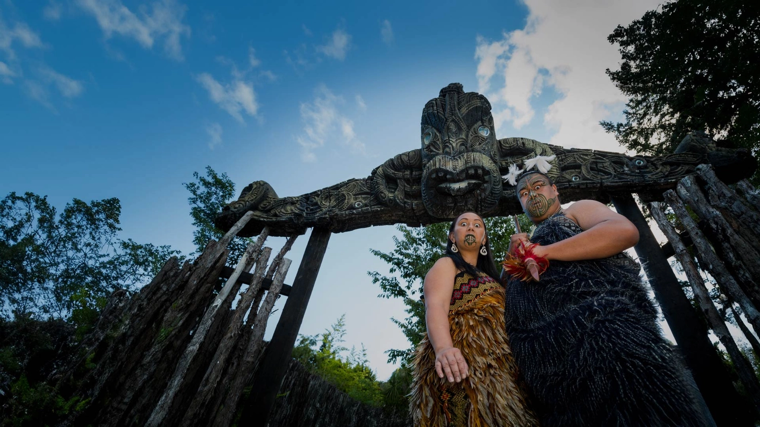 Māori man and woman greeting visitors to the Mitai Māori Village