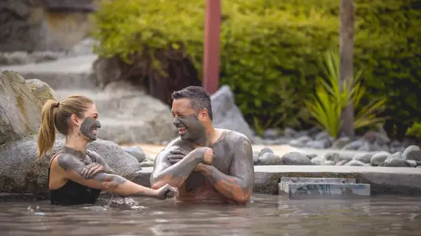 Two people in the Polynesian Spa in Rotorua