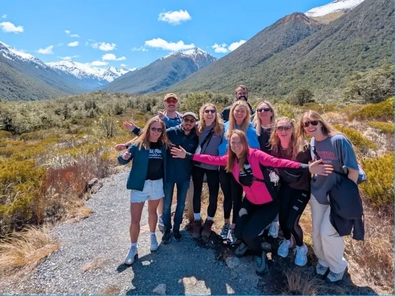 Wild Kiwi travellers on a guided small-group adventure in New Zealand’s Southern Alps, showcasing safe, comfortable, and eco-minded touring with scenic mountain views.