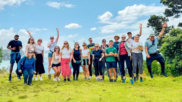 Group of people pose for a photo in Raglan