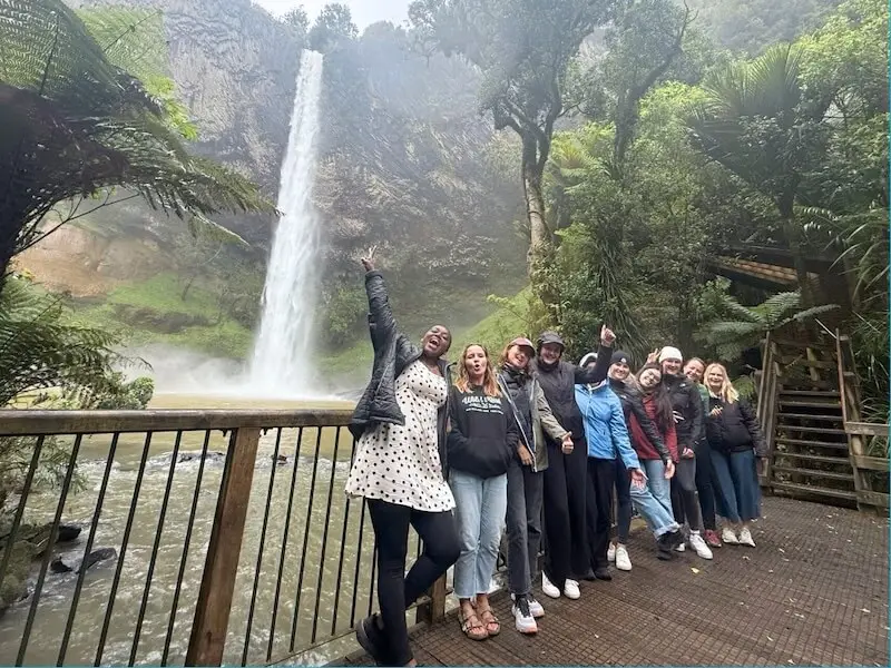 Wild Kiwi small-group tour at a New Zealand waterfall, reflecting the company’s commitment to sustainability, safety, and authentic nature-based experiences.