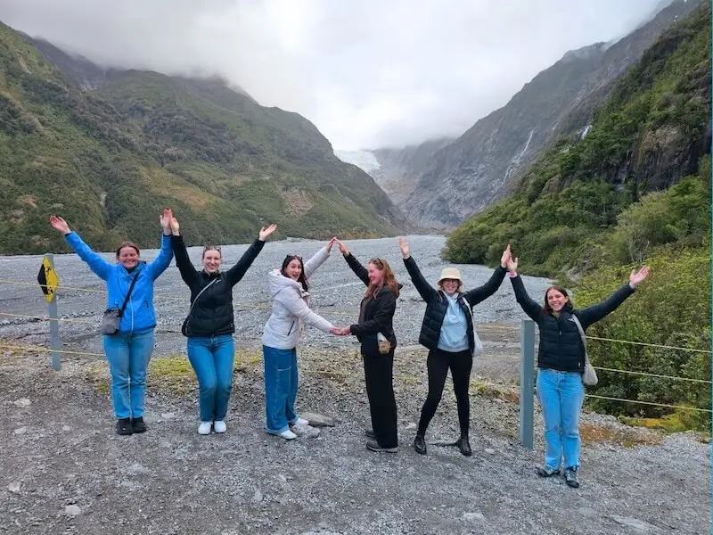 Wild Kiwi travellers visiting a glacier valley on a guided New Zealand adventure tour, emphasising comfort, safety, and connection with the environment.