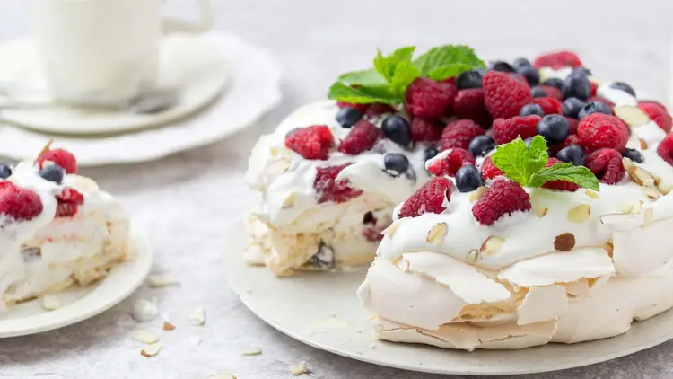 Pavlova dessert covered in strawberries