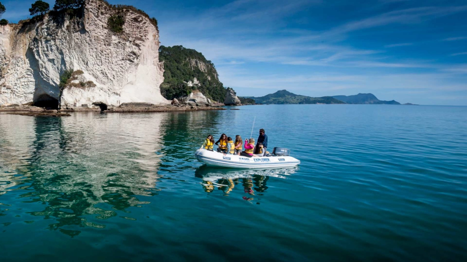 Group of people on a boat in a bay in the Coromandel